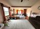 Spacious living room featuring hardwood floors, large windows, and a sectional sofa at 1026 Summer Way Dr, Shelbyville, IN 46176