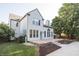 Home's exterior features a brick patio and lush landscaping at 107 W Columbine Ln, Westfield, IN 46074