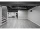 Open finished basement space with tiled floors, exposed beams, and sitting area at 107 W Columbine Ln, Westfield, IN 46074