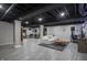 Finished basement with tile flooring, exposed ceiling, and a seating area with workout equipment at 107 W Columbine Ln, Westfield, IN 46074