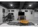 Finished basement features tiled floors, drop ceiling, and gaming setup at 107 W Columbine Ln, Westfield, IN 46074