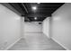 Finished basement space with tiled floor and exposed beams at 107 W Columbine Ln, Westfield, IN 46074