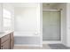 A bright bathroom featuring a soaking tub with a shower and a separated glass door shower at 107 W Columbine Ln, Westfield, IN 46074