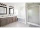 Bright bathroom featuring a dual vanity, garden tub, and glass-enclosed shower for a spa-like experience at 107 W Columbine Ln, Westfield, IN 46074