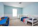 Light blue bedroom with a window, wainscotting, and carpet. Includes a bed and a play area at 107 W Columbine Ln, Westfield, IN 46074
