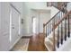 Inviting entryway with hardwood floors, staircase, and a white front door leading into the home at 107 W Columbine Ln, Westfield, IN 46074