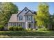 Charming two-story home with gray shutters and a well-manicured lawn, complemented by lush green trees at 107 W Columbine Ln, Westfield, IN 46074
