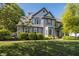 Charming two-story home with gray shutters and a well-manicured lawn, complemented by lush green trees at 107 W Columbine Ln, Westfield, IN 46074