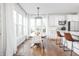 Bright kitchen with white cabinets, stainless steel appliances, and a dining area with large windows at 107 W Columbine Ln, Westfield, IN 46074