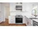 Beautiful kitchen with stainless steel appliances, white cabinets, and a subway tile backsplash at 107 W Columbine Ln, Westfield, IN 46074