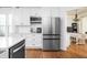 Contemporary kitchen with stainless steel appliances, white cabinets, and modern fixtures at 107 W Columbine Ln, Westfield, IN 46074