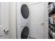Stacked white washer and dryer in laundry room with shelving on the right side at 107 W Columbine Ln, Westfield, IN 46074