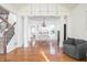 Open-concept living room with hardwood floors flowing into the dining and kitchen areas at 107 W Columbine Ln, Westfield, IN 46074