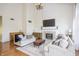 Spacious living room with a fireplace, stylish sofas, hardwood floors, and a decorative rug at 107 W Columbine Ln, Westfield, IN 46074
