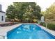 Beautiful swimming pool featuring crystal-clear water, with lush greenery and a basketball hoop in the background at 107 W Columbine Ln, Westfield, IN 46074