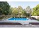 Beautiful backyard featuring a pristine pool surrounded by lush landscaping, perfect for relaxation and entertainment at 107 W Columbine Ln, Westfield, IN 46074