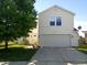 Lovely two-story home with a well-manicured lawn, two car garage, and inviting front entrance at 10795 Albertson Dr, Indianapolis, IN 46231