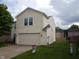 A bright two-story home featuring a two-car garage and well-kept lawn at 10795 Albertson Dr, Indianapolis, IN 46231