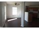 Bright living room featuring wood flooring and a ceiling fan at 10795 Albertson Dr, Indianapolis, IN 46231