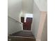 View of carpeted stairs with white risers and dark treads leading to a wood floor at 10795 Albertson Dr, Indianapolis, IN 46231