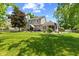 Lush backyard showcasing manicured lawn, mature trees, and a patio area perfect for outdoor enjoyment at 10988 Eaton Ct, Fishers, IN 46038