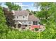Landscaped backyard with a brick patio, outdoor dining set, and a screened porch, perfect for entertaining at 10988 Eaton Ct, Fishers, IN 46038