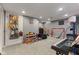 Spacious finished basement offers a versatile space for play or relaxation with carpet and neutral paint at 10988 Eaton Ct, Fishers, IN 46038