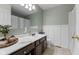 Well-lit bathroom featuring updated vanity, decorative mirror, and framed tile wall at 10988 Eaton Ct, Fishers, IN 46038