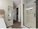Modern bathroom with a glass-enclosed shower, a vanity, and a walk-in closet at 10988 Eaton Ct, Fishers, IN 46038