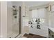 Bright bathroom featuring tiled shower, soaking tub with window and stylish fixtures at 10988 Eaton Ct, Fishers, IN 46038