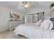 Cozy bedroom with vaulted ceiling, soft pink details, mounted TV, and a barn door at 10988 Eaton Ct, Fishers, IN 46038