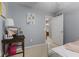 Comfortable bedroom with a desk area and a view towards the hallway and bathroom at 10988 Eaton Ct, Fishers, IN 46038