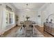 Bright dining room featuring a modern chandelier, large window, and stylish decor at 10988 Eaton Ct, Fishers, IN 46038