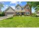 Charming two-story home featuring a well-manicured lawn, covered front porch, and an American flag at 10988 Eaton Ct, Fishers, IN 46038