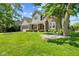 Charming two-story home featuring a well-manicured lawn, covered front porch, and mature trees at 10988 Eaton Ct, Fishers, IN 46038