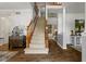 Inviting foyer with hardwood floors, carpeted staircase, and decorative accents at 10988 Eaton Ct, Fishers, IN 46038