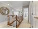Bright hallway showcasing wood railings and views into adjacent living spaces and bedrooms at 10988 Eaton Ct, Fishers, IN 46038