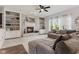 Spacious living room with a fireplace, built-in shelves, and large windows at 10988 Eaton Ct, Fishers, IN 46038