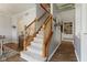 Carpeted stairs with wood railing, leading to the upper level at 10988 Eaton Ct, Fishers, IN 46038