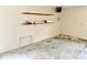 Unfinished basement featuring open space and wood shelving at 1103 Canal St, Anderson, IN 46012