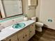 Bathroom featuring turquoise sink and accents, with white countertop and wood-look floors at 1103 Canal St, Anderson, IN 46012