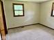 Cozy bedroom with neutral carpeting and natural light from two large windows at 1103 Canal St, Anderson, IN 46012