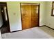 This bedroom features a neutral carpet, light walls, and a closet at 1103 Canal St, Anderson, IN 46012