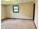 Bedroom featuring carpeting and natural light from a large window at 1103 Canal St, Anderson, IN 46012