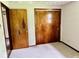 Bedroom with carpeting and closet with wood doors at 1103 Canal St, Anderson, IN 46012