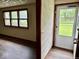 The home's entry featuring new flooring, a storm door and a view of the front yard from the window at 1103 Canal St, Anderson, IN 46012