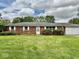 Charming single-story brick home with an attached two-car garage and well-manicured lawn at 1103 Canal St, Anderson, IN 46012