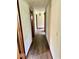 Hallway with wood-look floors and white walls leading to other rooms in the home at 1103 Canal St, Anderson, IN 46012