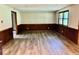 Bright living room featuring wood-look floors, white walls, and natural light from a double window at 1103 Canal St, Anderson, IN 46012
