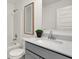 Bathroom featuring a tub with shower, white vanity with grey countertop, and a framed print for decor at 11912 Vale St, Indianapolis, IN 46235